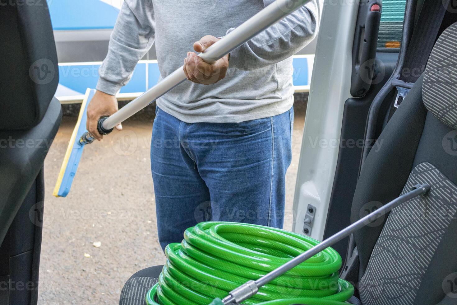 Cleaner manwith your tools. Conceptual image of car washing job. photo