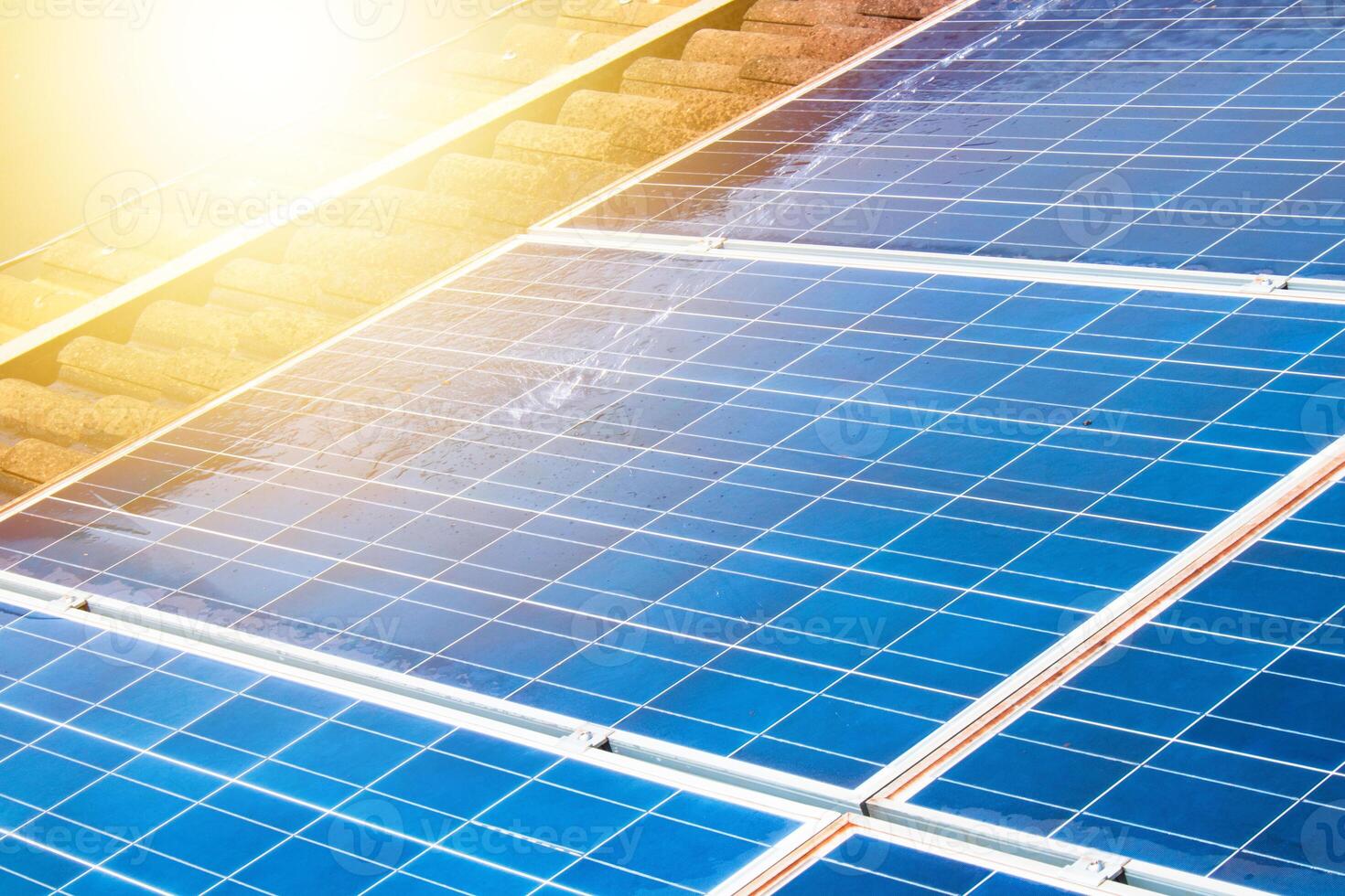 Solar worker cleaning photovoltaic panels with brush and water. Photovoltaic cleaning, before and after concept image. Space for text. photo