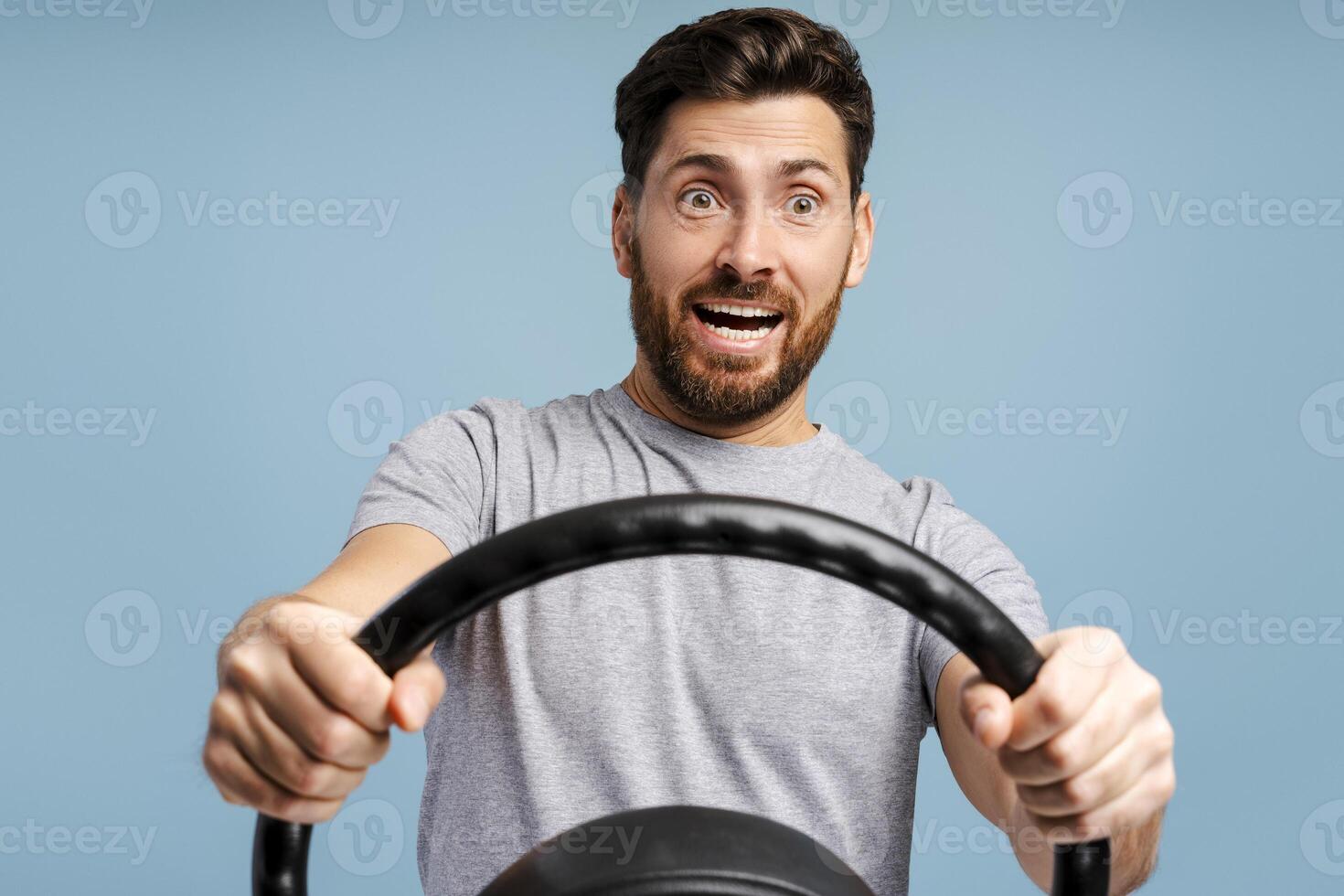 Portrait of excited bearded Hispanic man holding helm looking away driver driving. Insurance concept photo