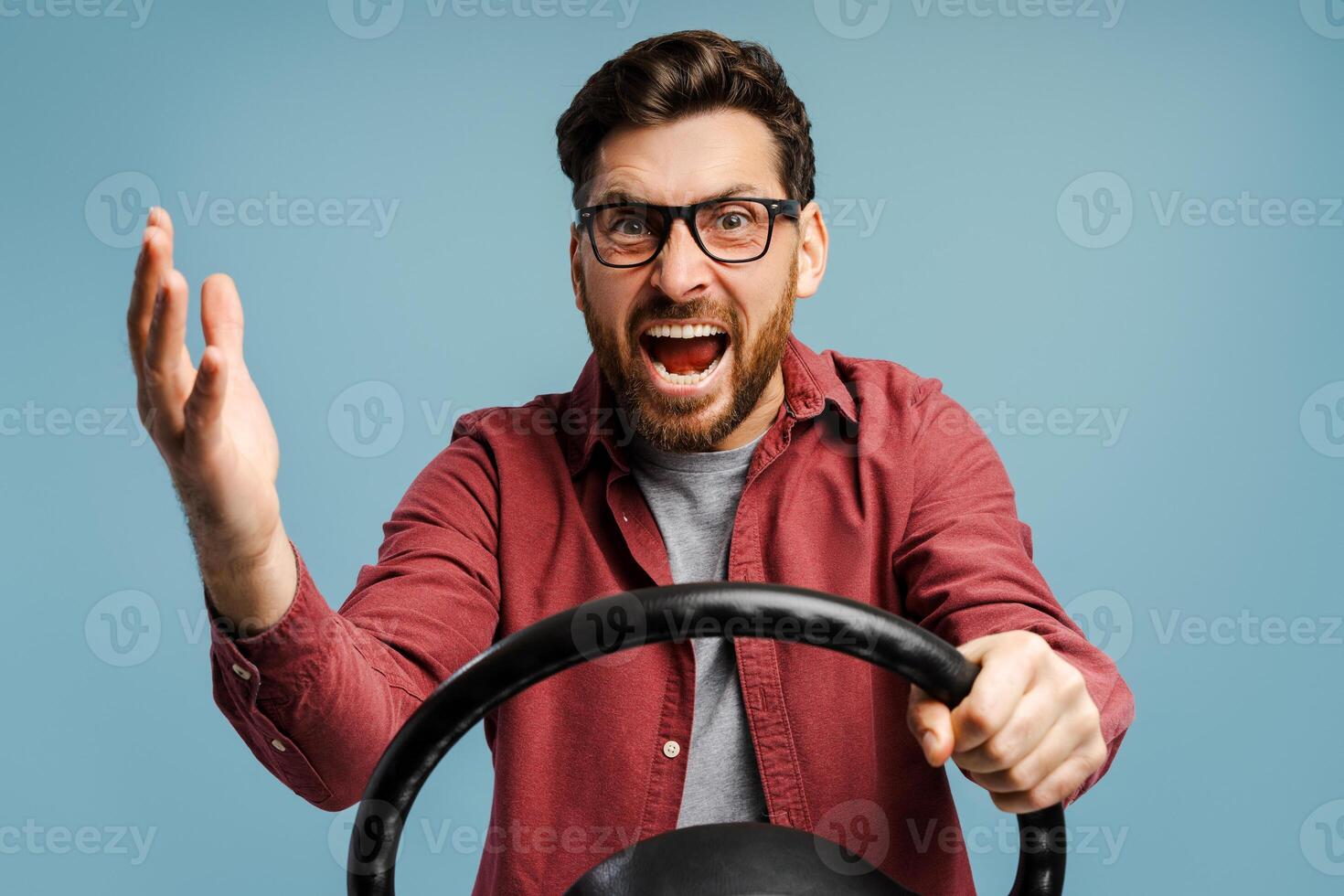 Portrait of negative, angry bearded Latin man wearing eyeglasses holding helm, shouting, gesturing photo