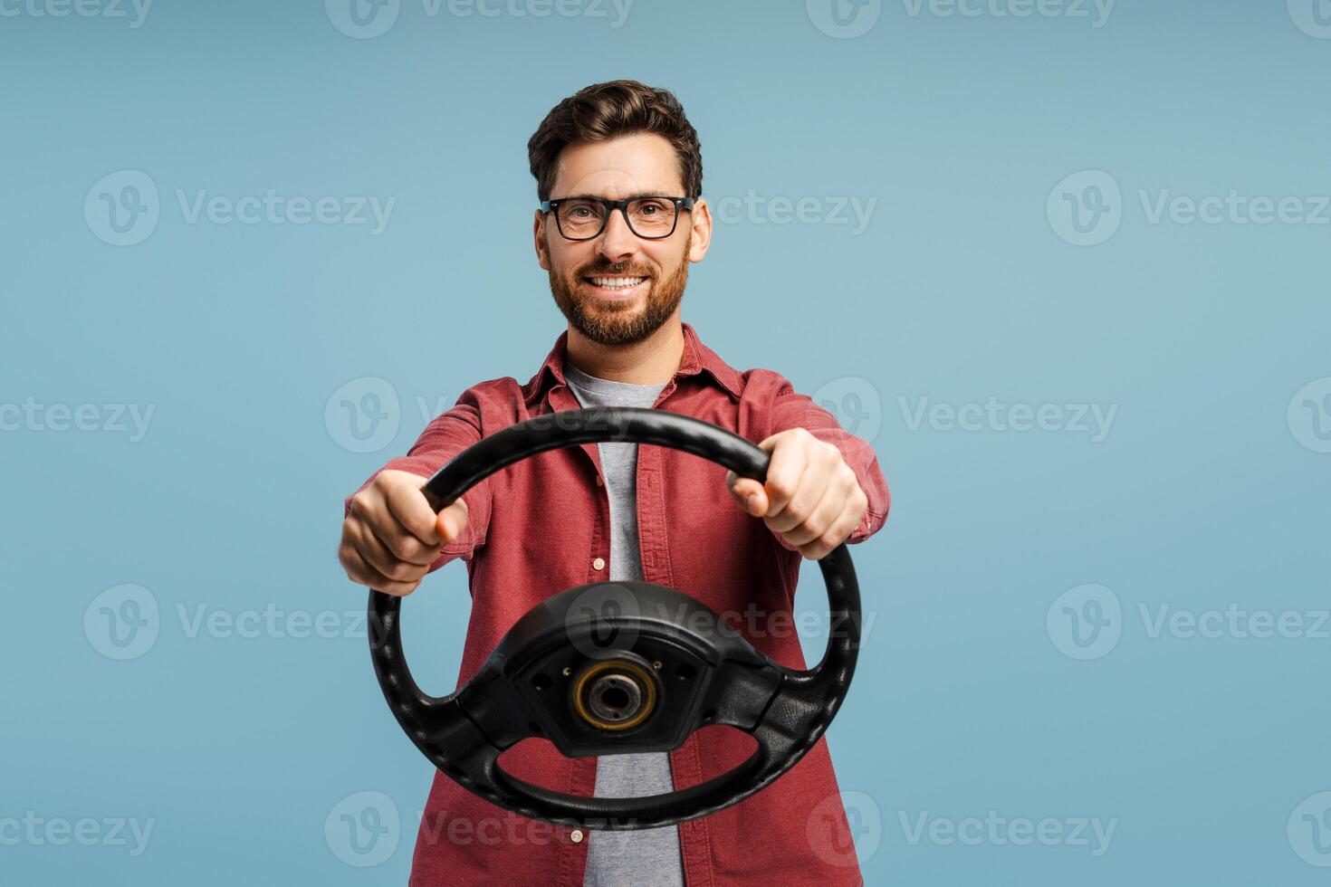 Portrait of smiling, happy bearded Hispanic man, driver wearing eyeglasses, holding helm photo