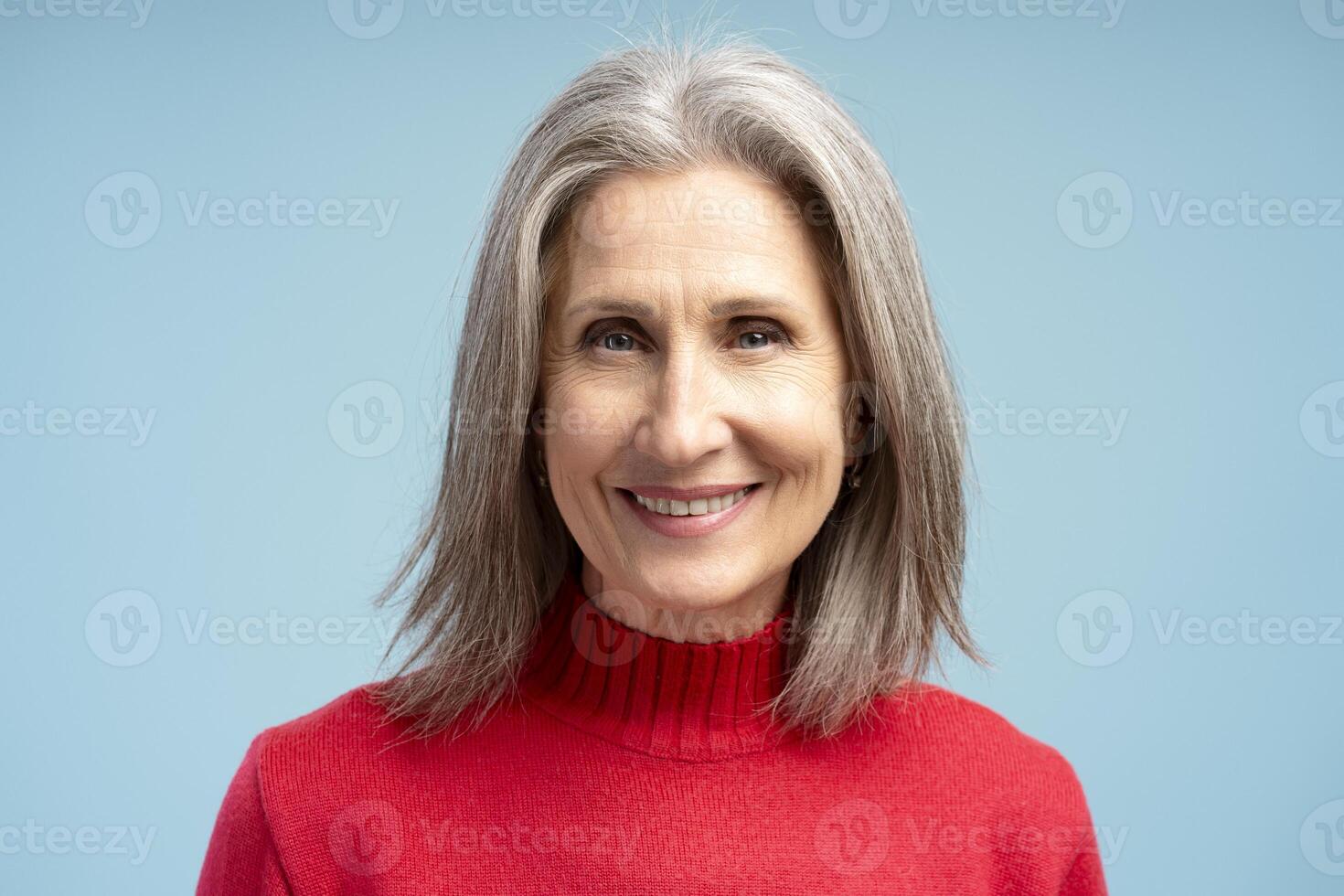 Portrait of happy, smiling gray haired senior woman, fashion model posing, looking at camera photo