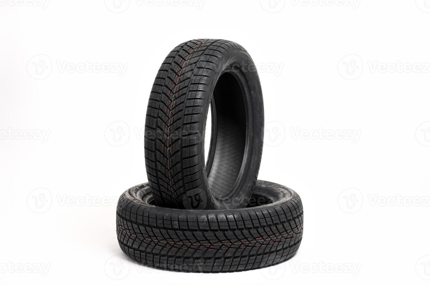 Two new winter tires standing on white background photo