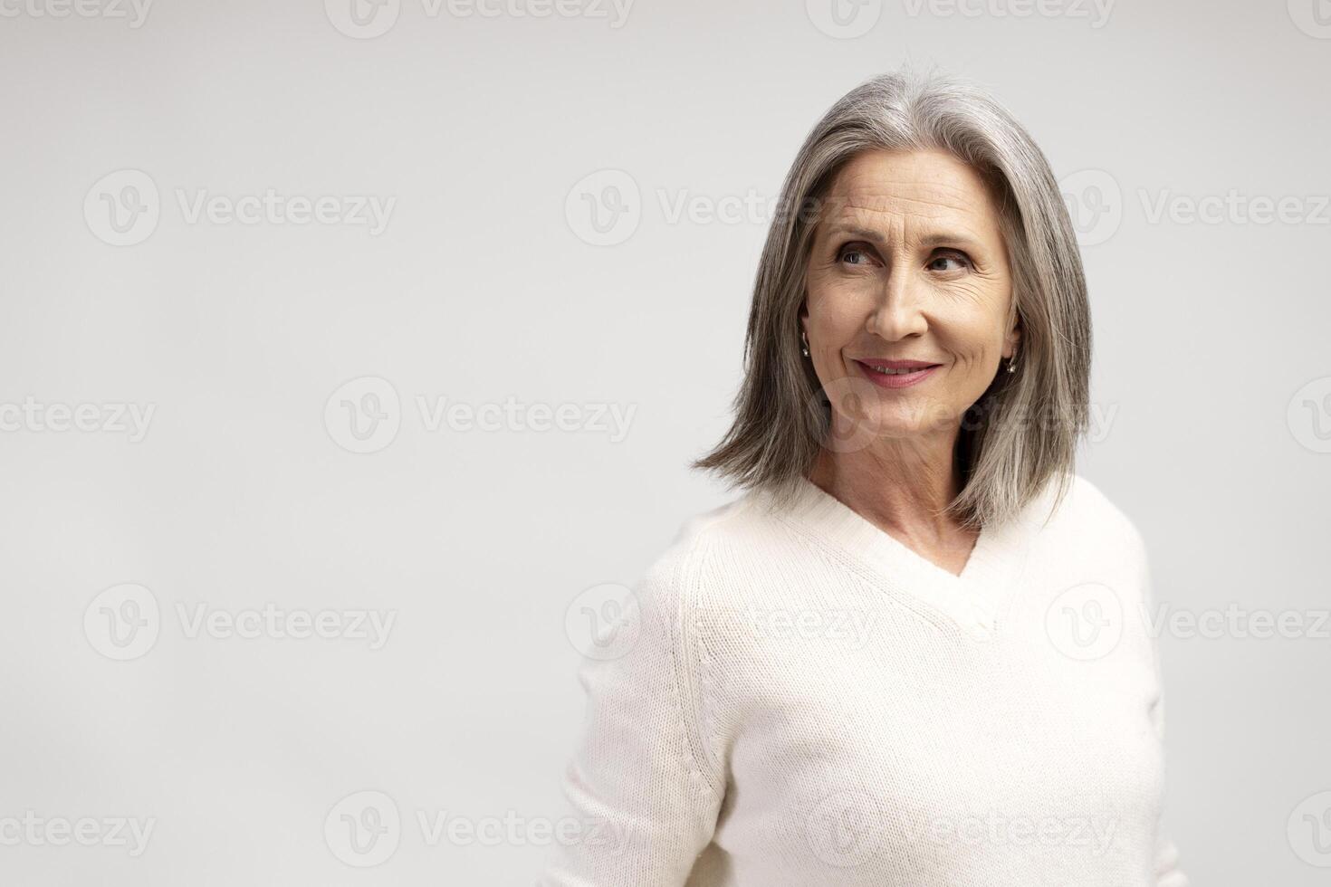 Portrait of smiling, beautiful senior woman looking away on copy space, mature female photo