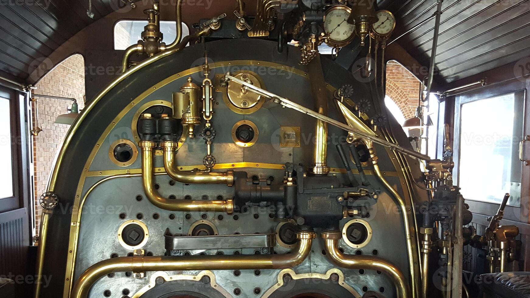 A close up of a steam engine with a lot of pipes photo