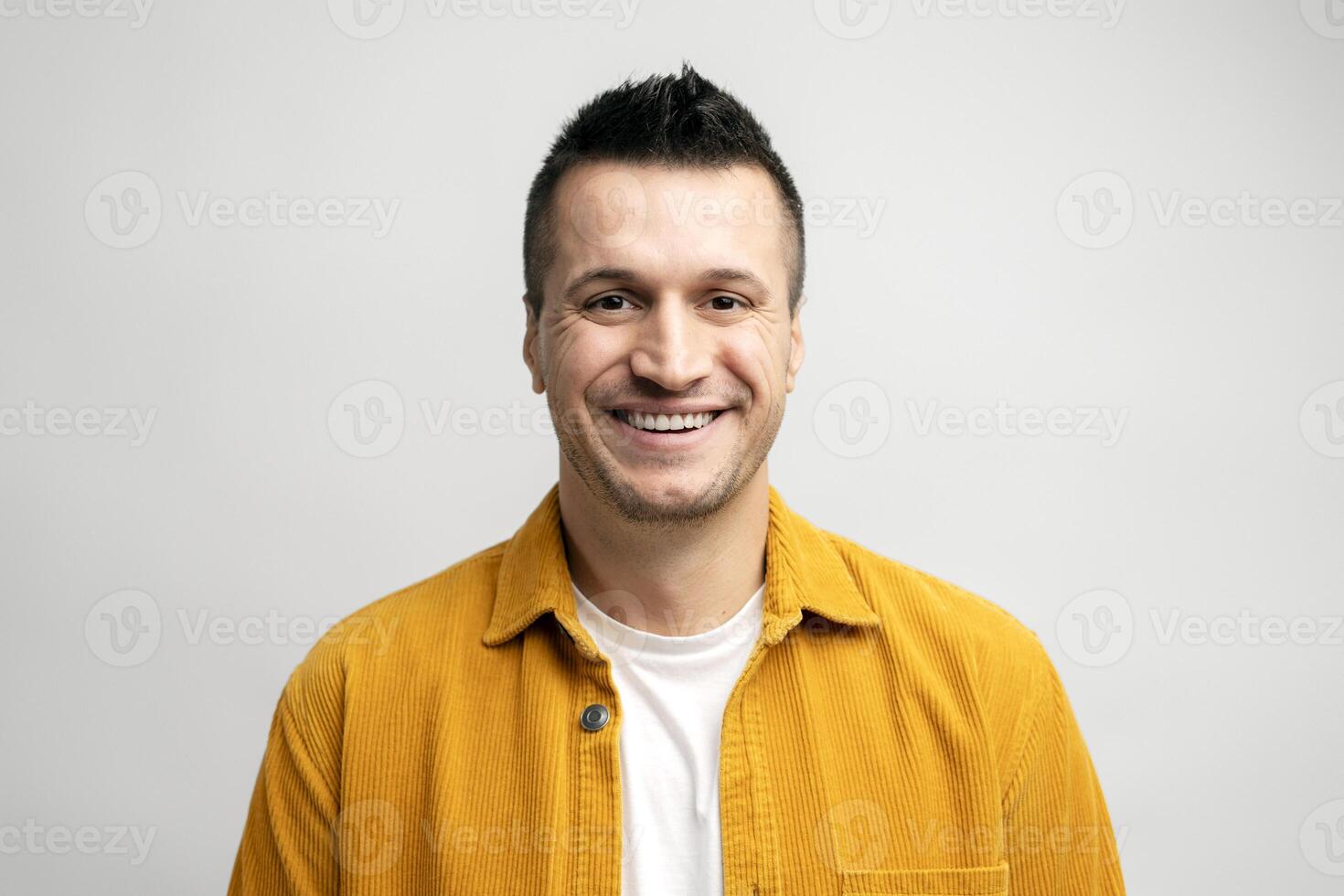 Cheerful man smiling and showing positive emotions on white background photo