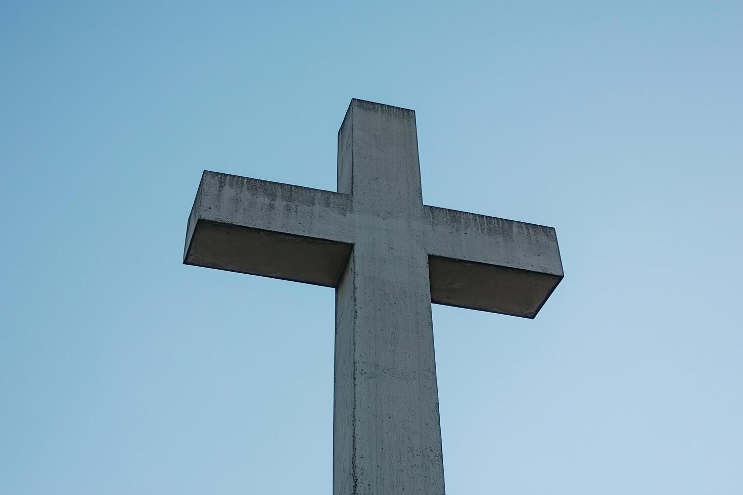 A Majestic Concrete Cross Set Against a Serene Sky photo