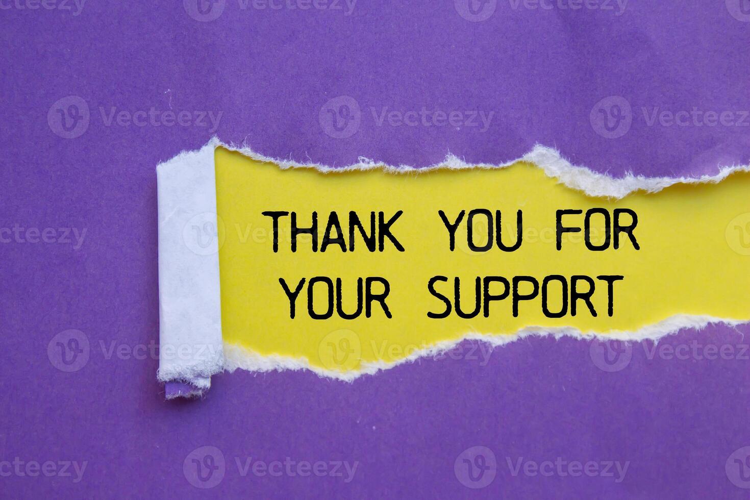 Thank you for your support message written on ripped torn purple paper with yellow background. Conceptual thank you for your support symbol. Copy space. photo