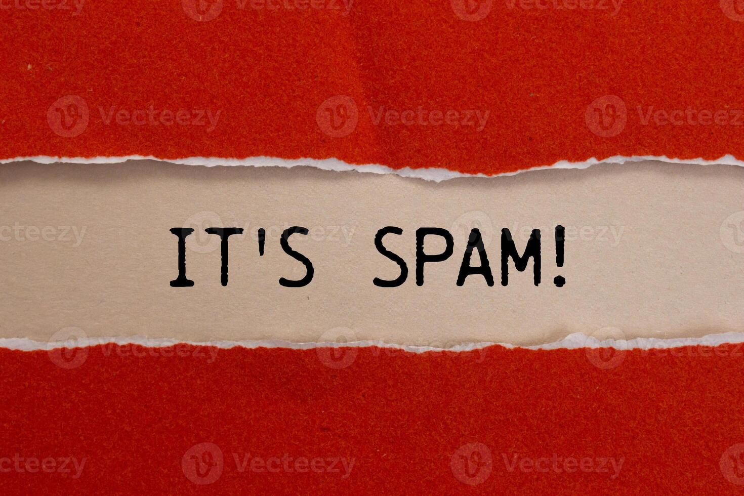 It's spam message written on ripped torn red paper with beige background. Conceptual it's spam symbol. Copy space. photo