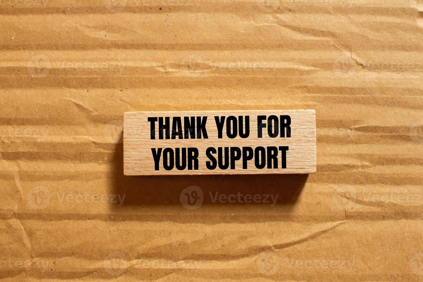Thank you for your support message written on wooden block with cardboard background. Conceptual thank you for your support symbol. Copy space. photo