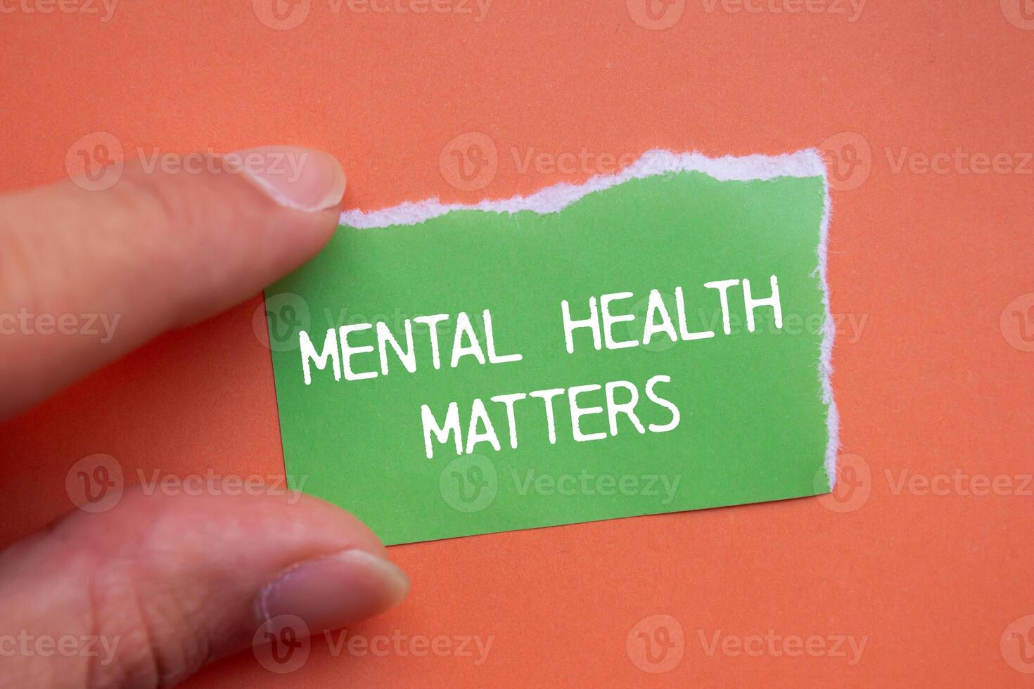 Mental health matters message written on ripped green torn paper with orange background. Conceptual mental health matters symbol. Copy space. photo