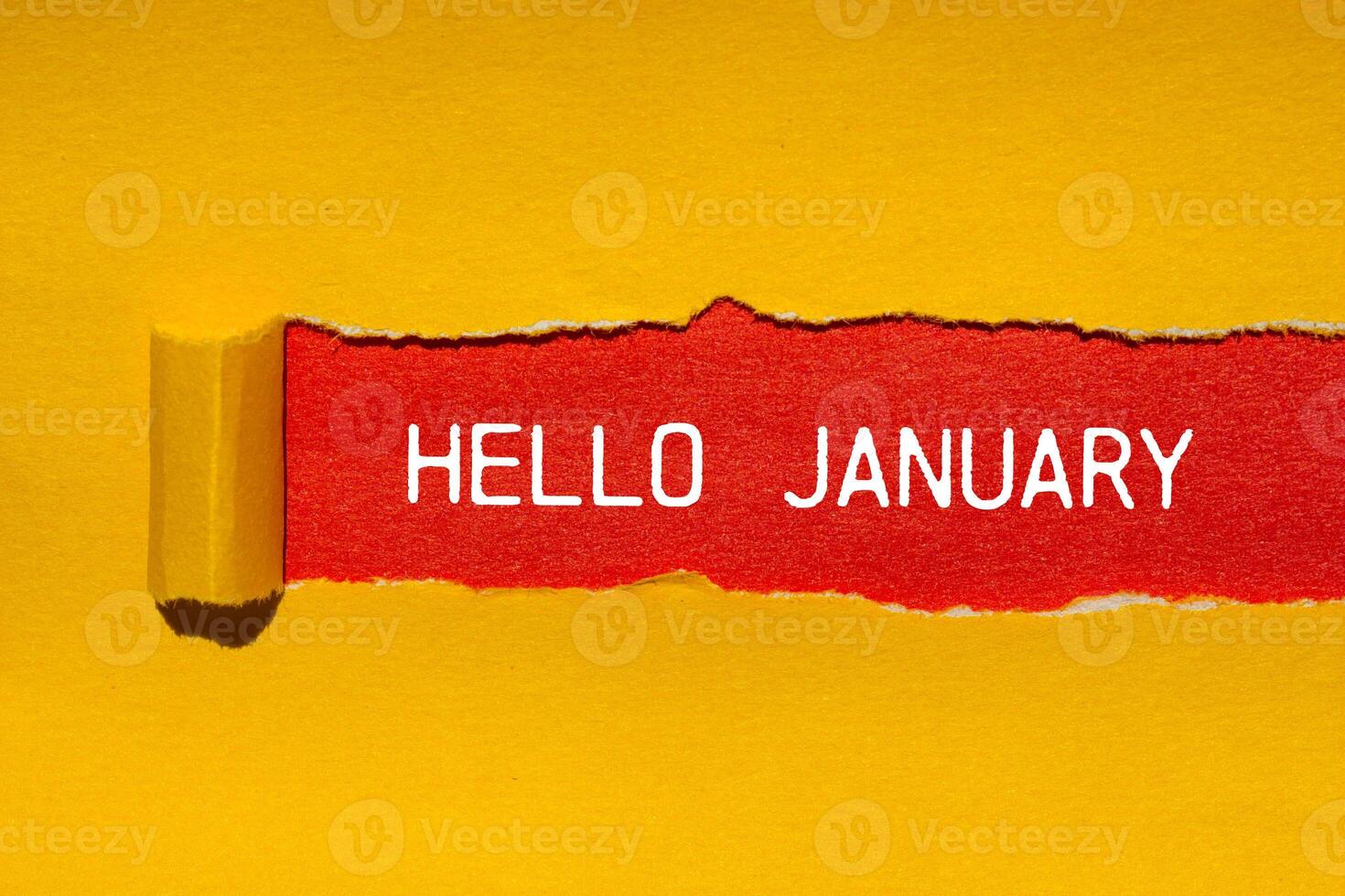 Hello january message written on ripped torn yellow paper with red background. Conceptual hello january symbol. Copy space. photo