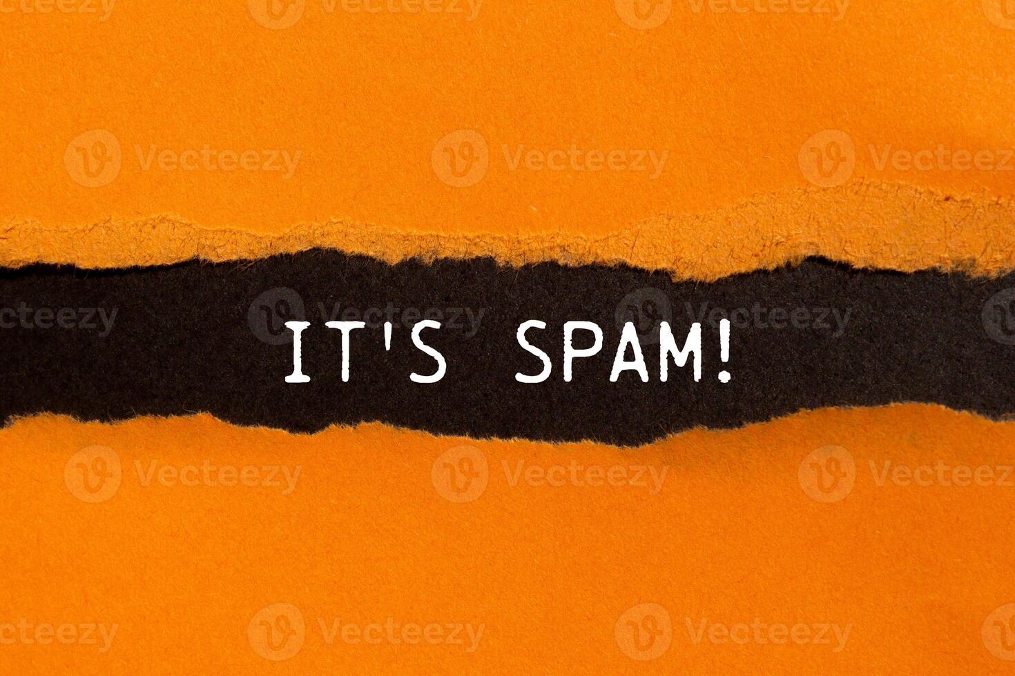 It's spam message written on ripped torn orange paper with black background. Conceptual it's spam symbol. Copy space. photo