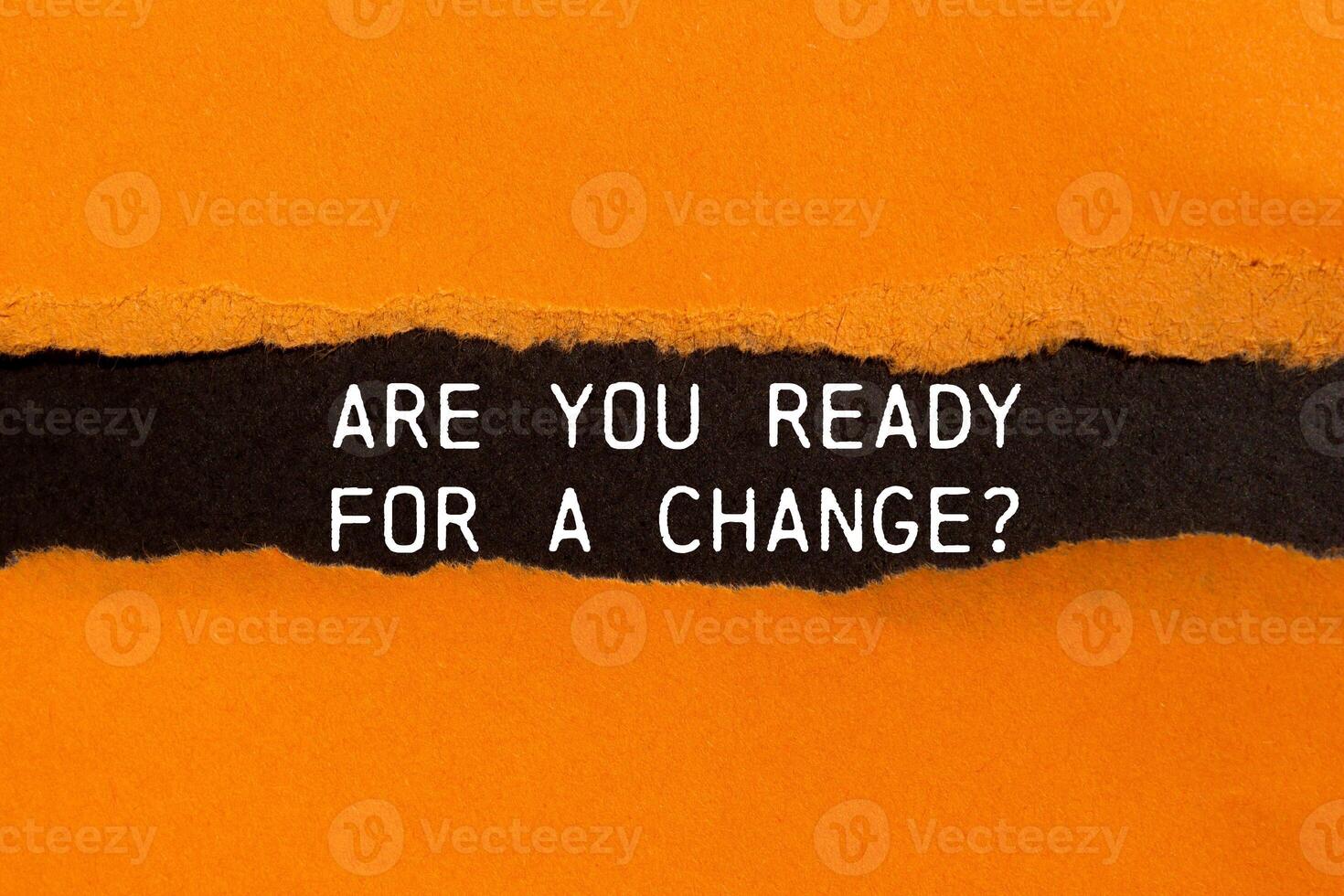 Are you ready for a change message written on ripped torn orange paper with black background. Conceptual are you ready for a change symbol. Copy space. photo