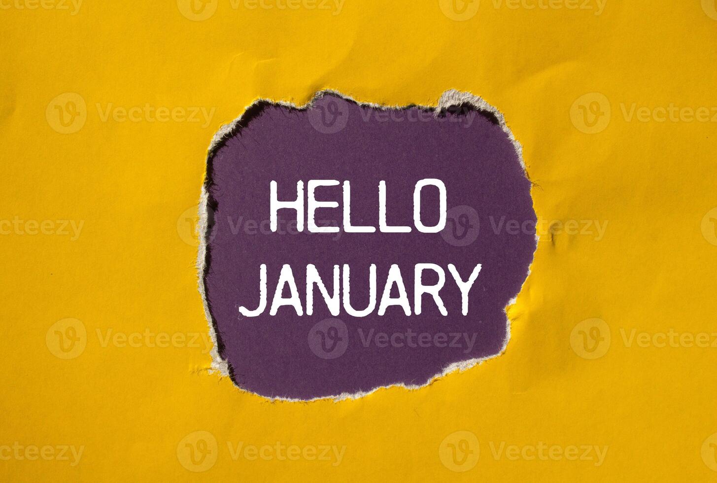 Hello january message written on ripped torn yellow paper with purple background. Conceptual hello january symbol. Copy space. photo