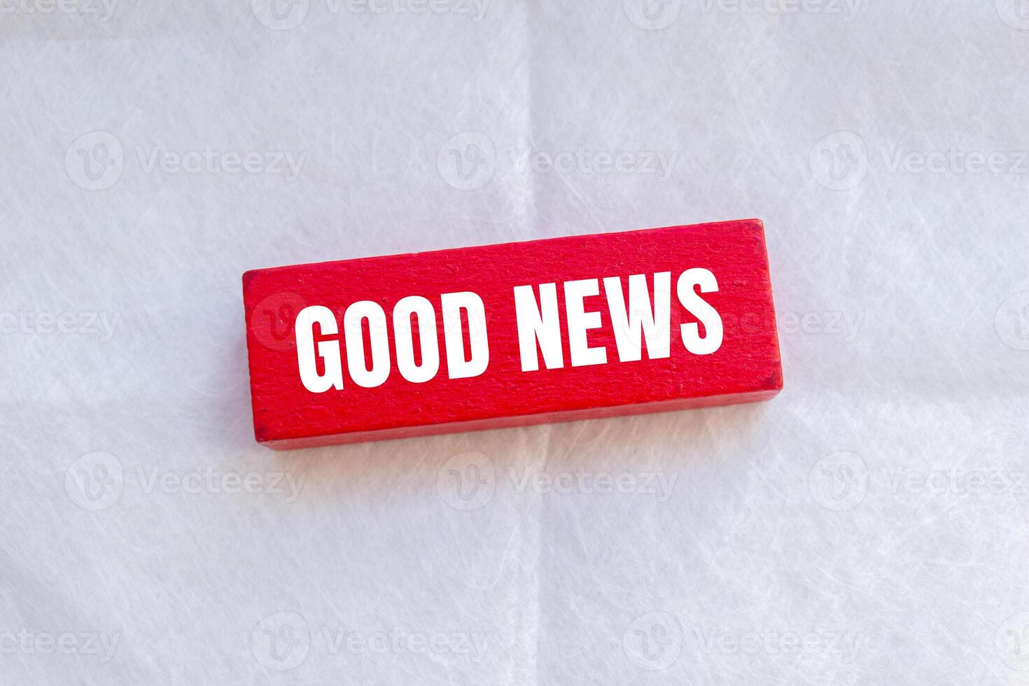 Good news message written on wooden red block with white background. Conceptual good news symbol. Copy space. photo
