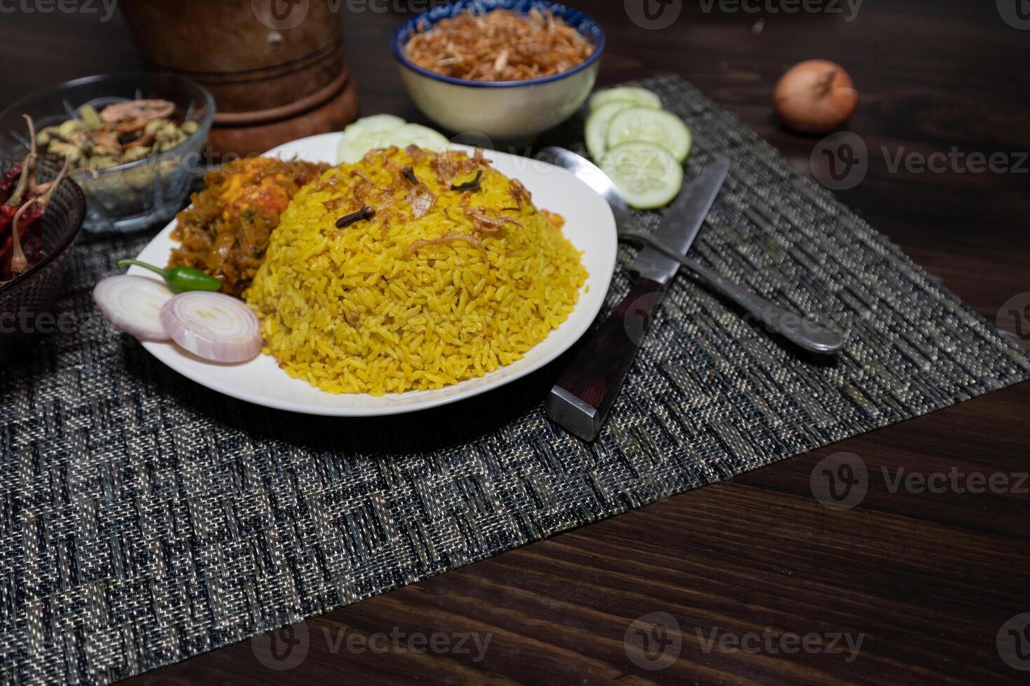 Egg khichuri rice with fried onion served in plated isolated on background side view of Bangladeshi food photo