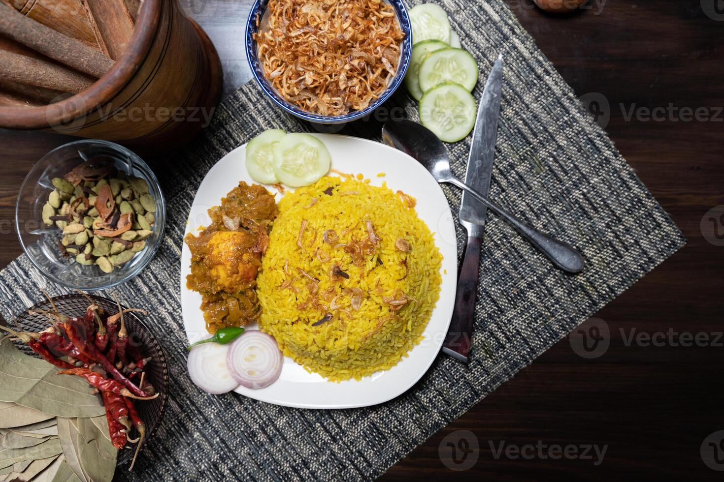 Egg khichuri rice with fried onion served in plated isolated on background side view of Bangladeshi food photo