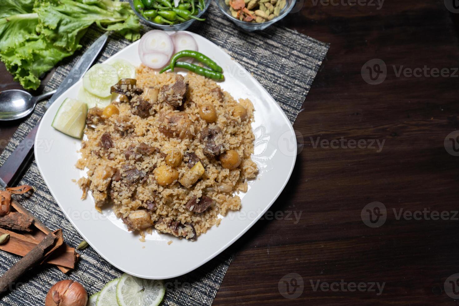 Beef Biryani Tehari Rice with chili lime on a plate white background photo