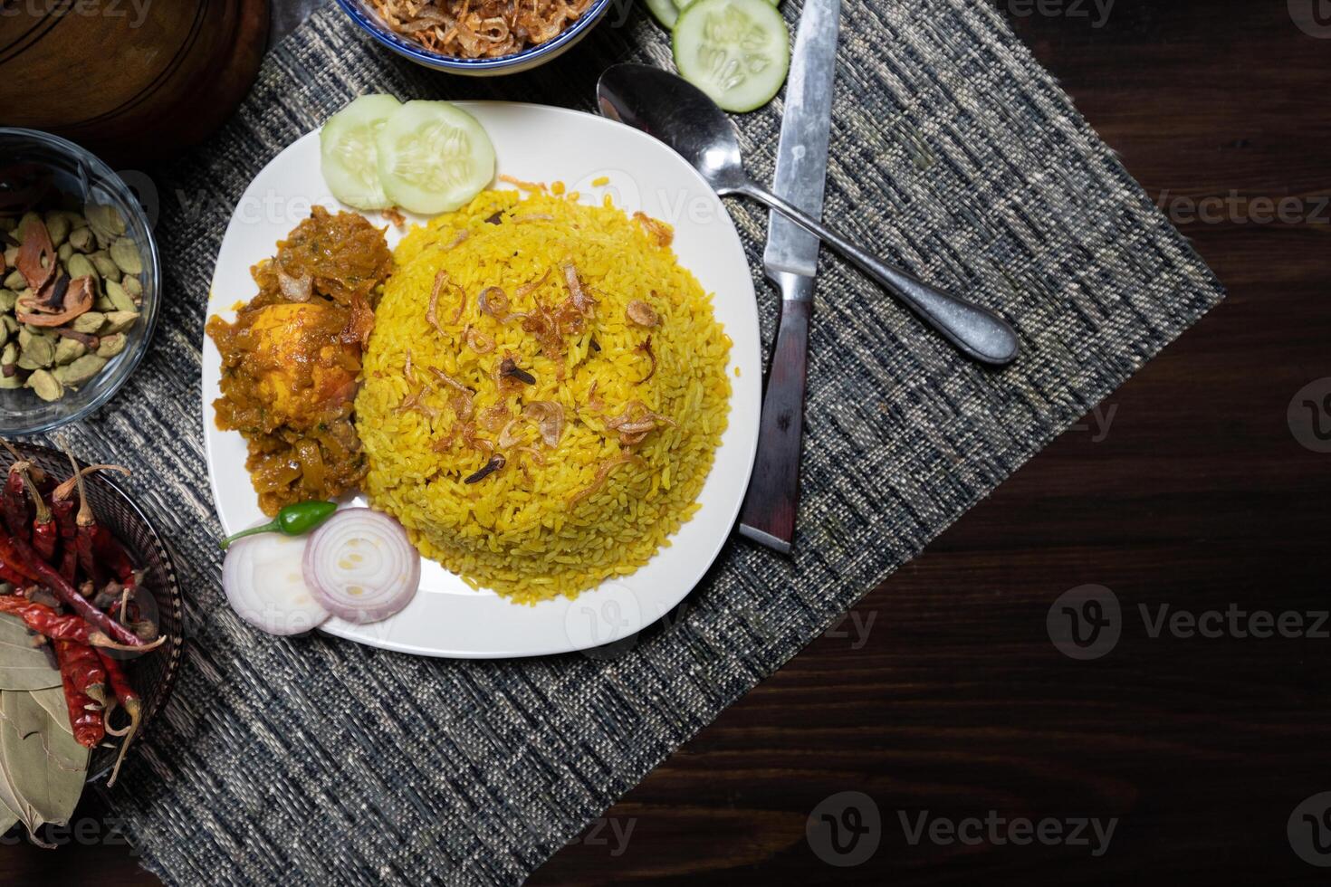 Egg khichuri rice with fried onion served in plated isolated on background side view of Bangladeshi food photo