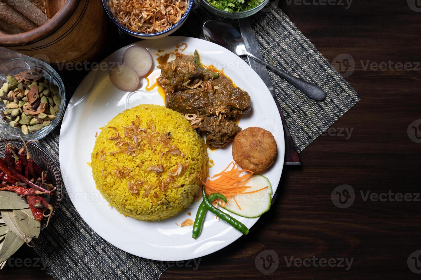 Khichdi or Khichuri with Beef Bhuna, kebab, and salad served in a dish isolated on the background top view of Bangladesh food photo