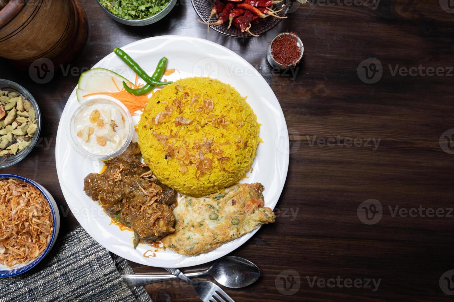 Beef Bhuna Khichuri rice with egg, kheer, and salad served in a dish isolated on the background top view of Bangladesh food photo