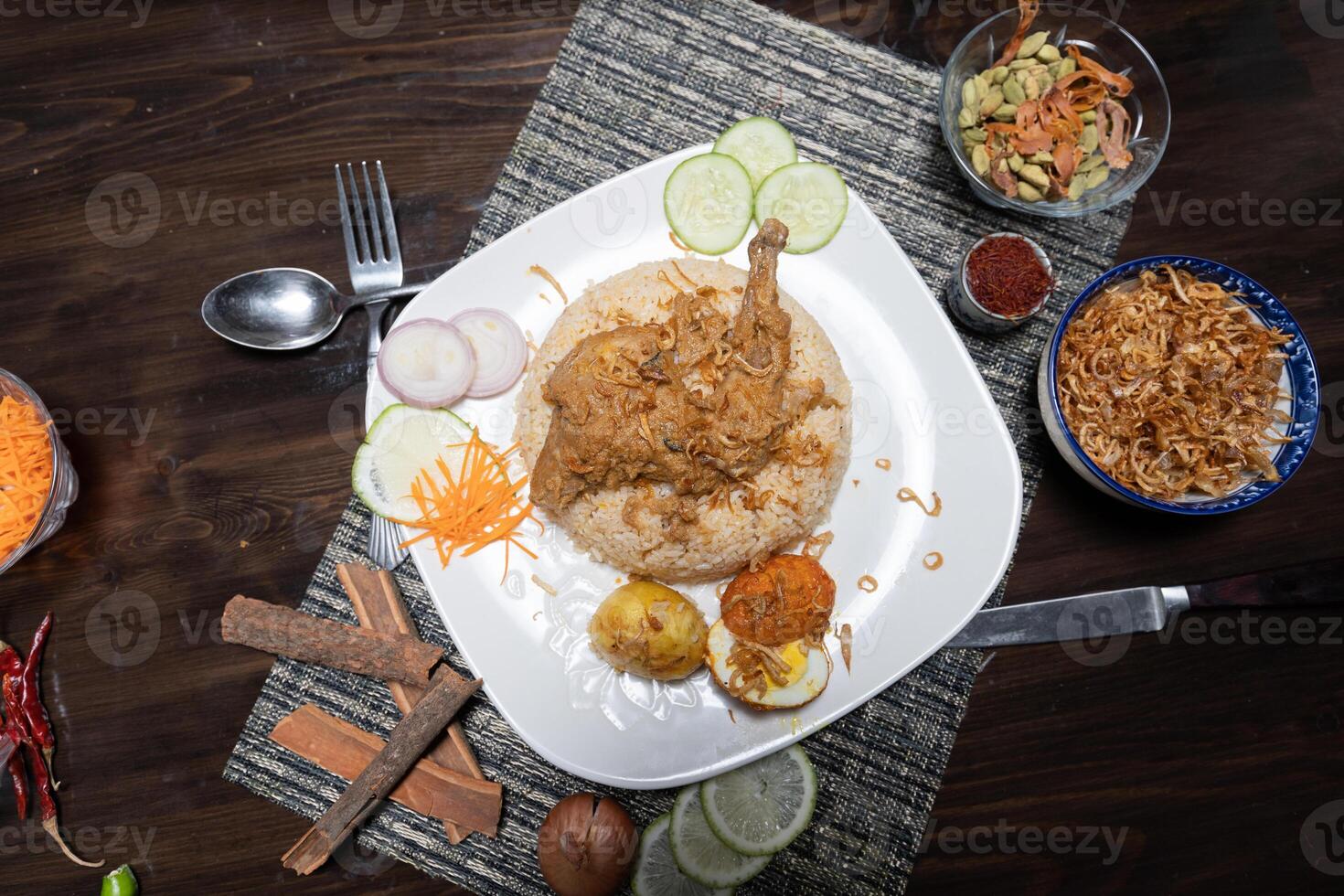 Delicious homemade roast chicken legs with fried onions served with spicy pulao close-up in a plate on the table. Horizontal photo