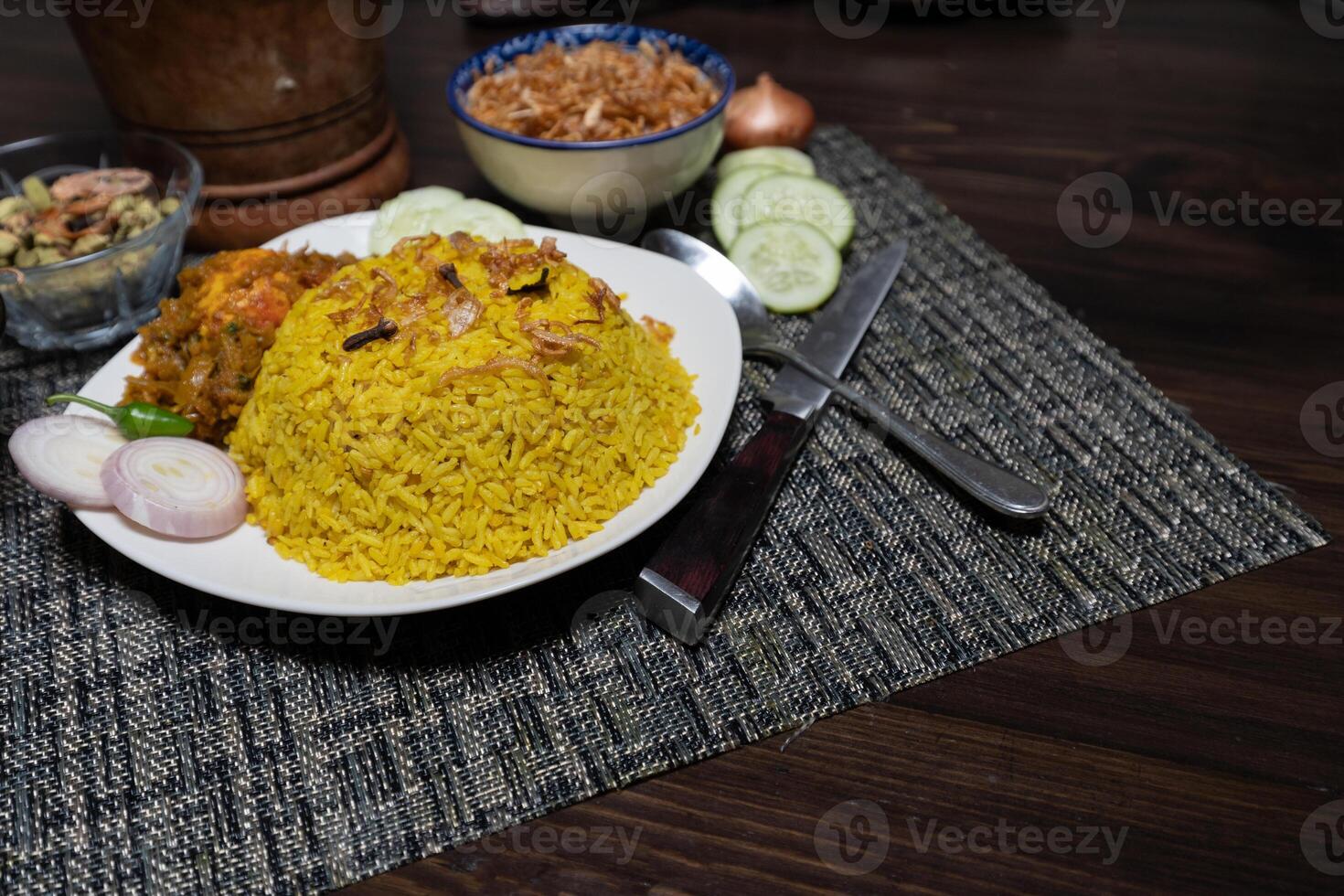Egg khichuri rice with fried onion served in plated isolated on background side view of Bangladeshi food photo