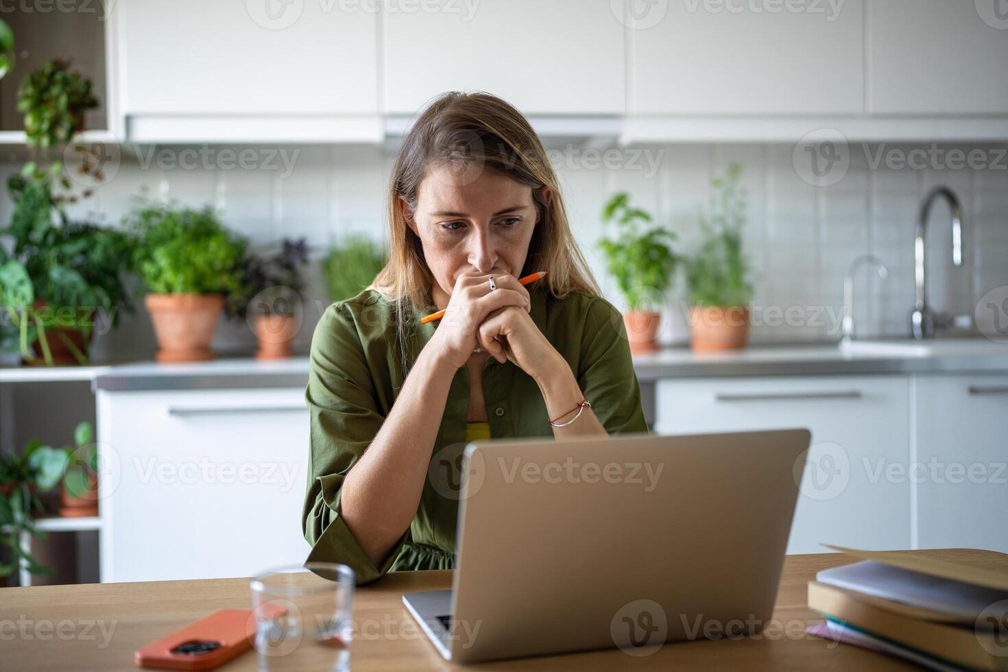 Focused thoughtful woman with laptop deep in process of solving tasks problems remote work IT field. photo