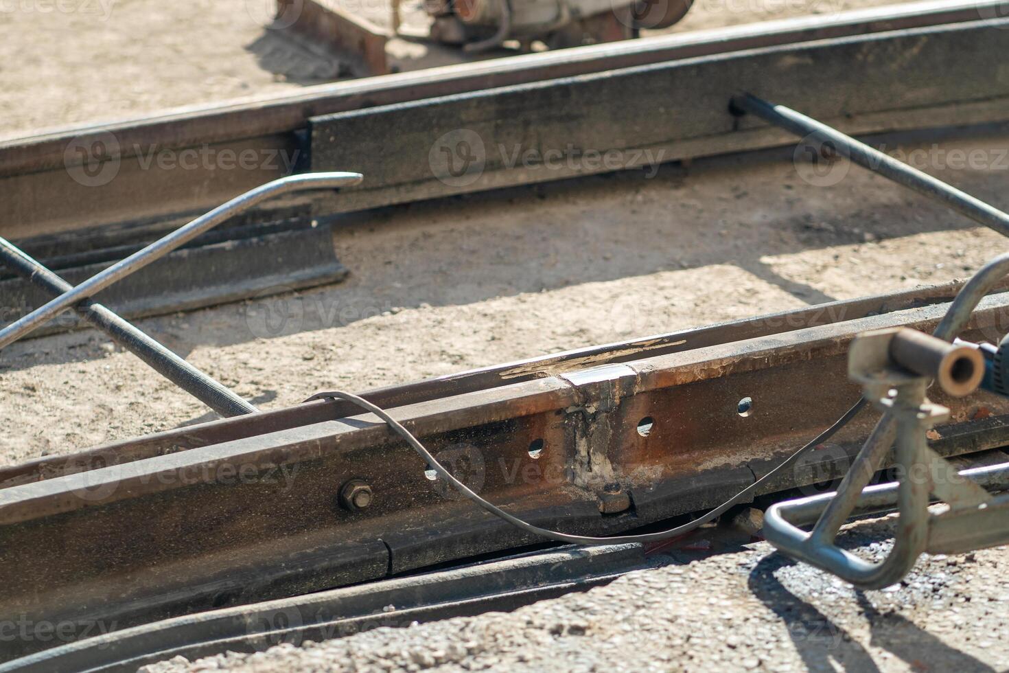 Welding streetcar rails during street repairs in city. Timely replacement of worn-out tramway rails. photo