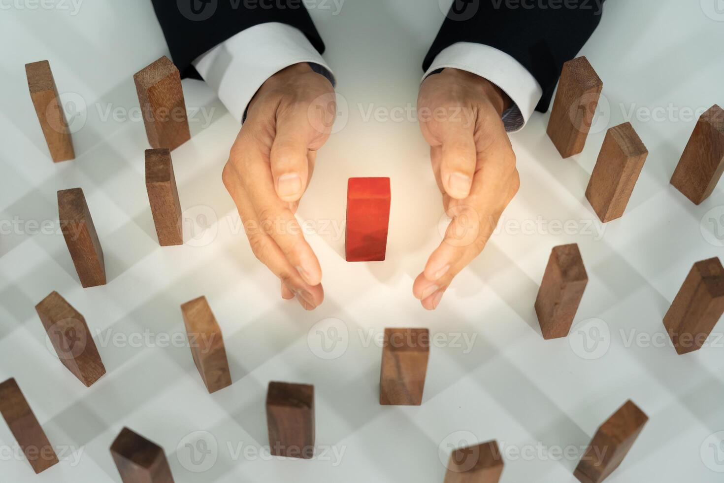 insurance with hands protect domino. Businessman hands stop dominoes falling in house crisis. business risk control and planning and strategies to run prevent insurance businesses. photo