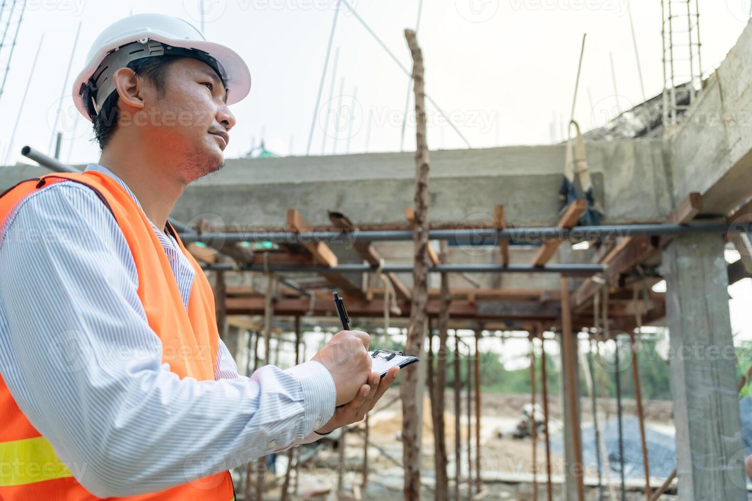 inspector or engineer is inspecting construction and quality assurance new house using a checklist. Engineers or architects or contactor work to build the house before handing it over to the homeowner photo
