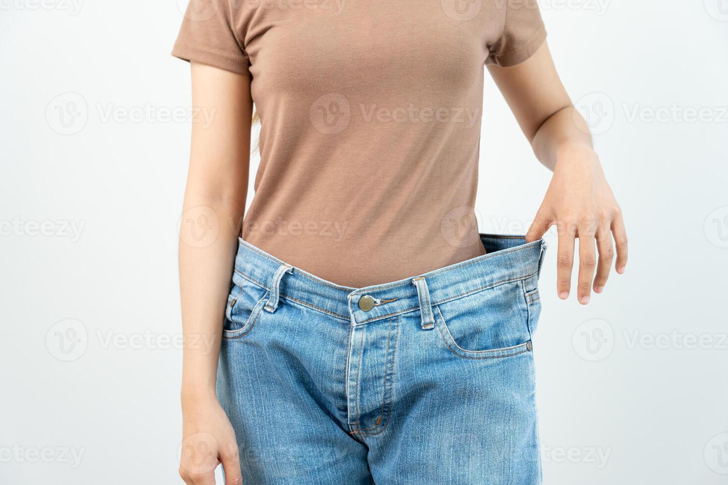 Women showing results of diet. Beautiful shape. female have a reduced waist size after under going a weight loss corse. can not wear jeans due to weight loss. balance, control, routines, exercise. photo
