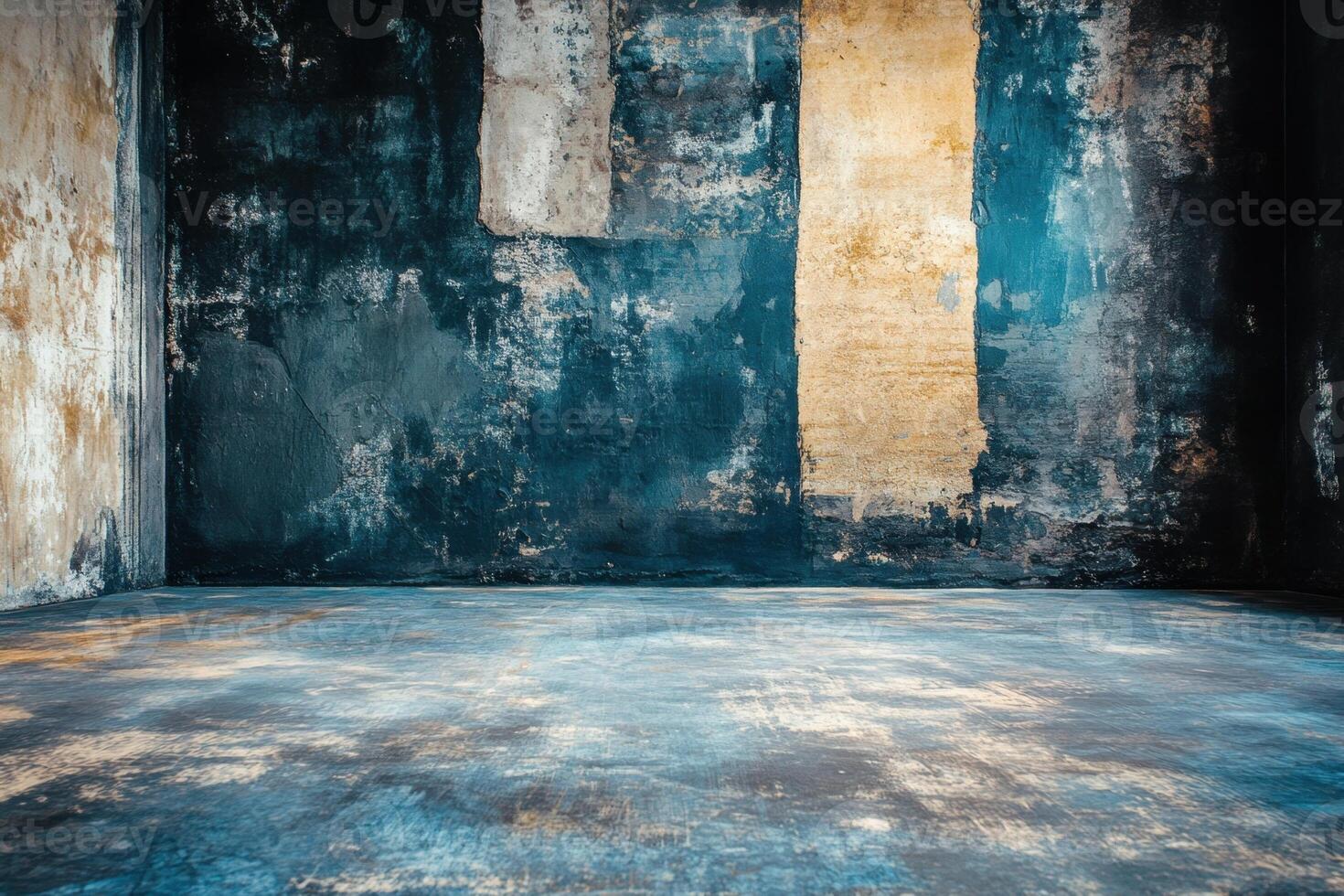 A grunge room with an old, distressed wall and concrete floor. photo