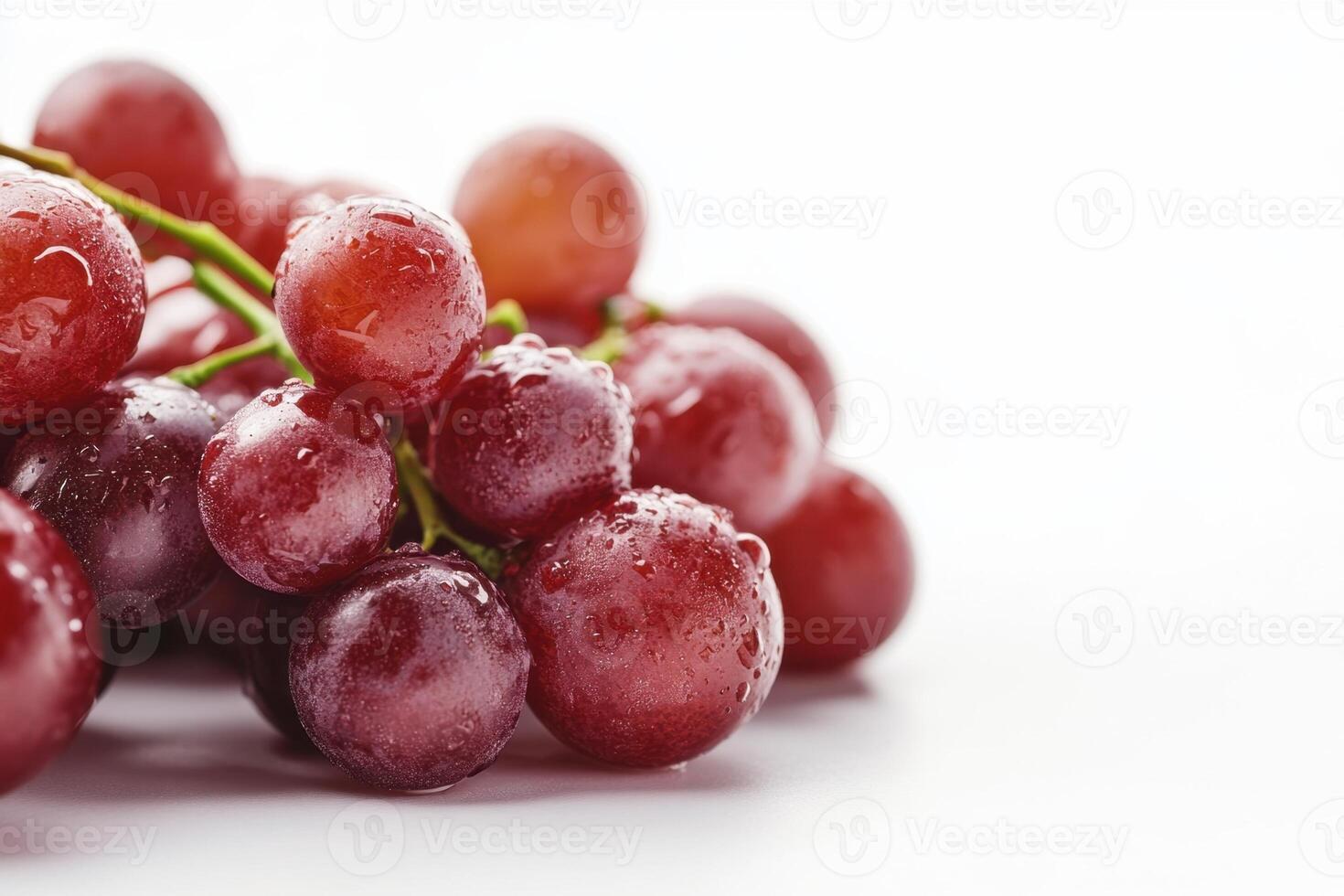 Close-up of a bunch of red grapes with water droplets on a white background. photo