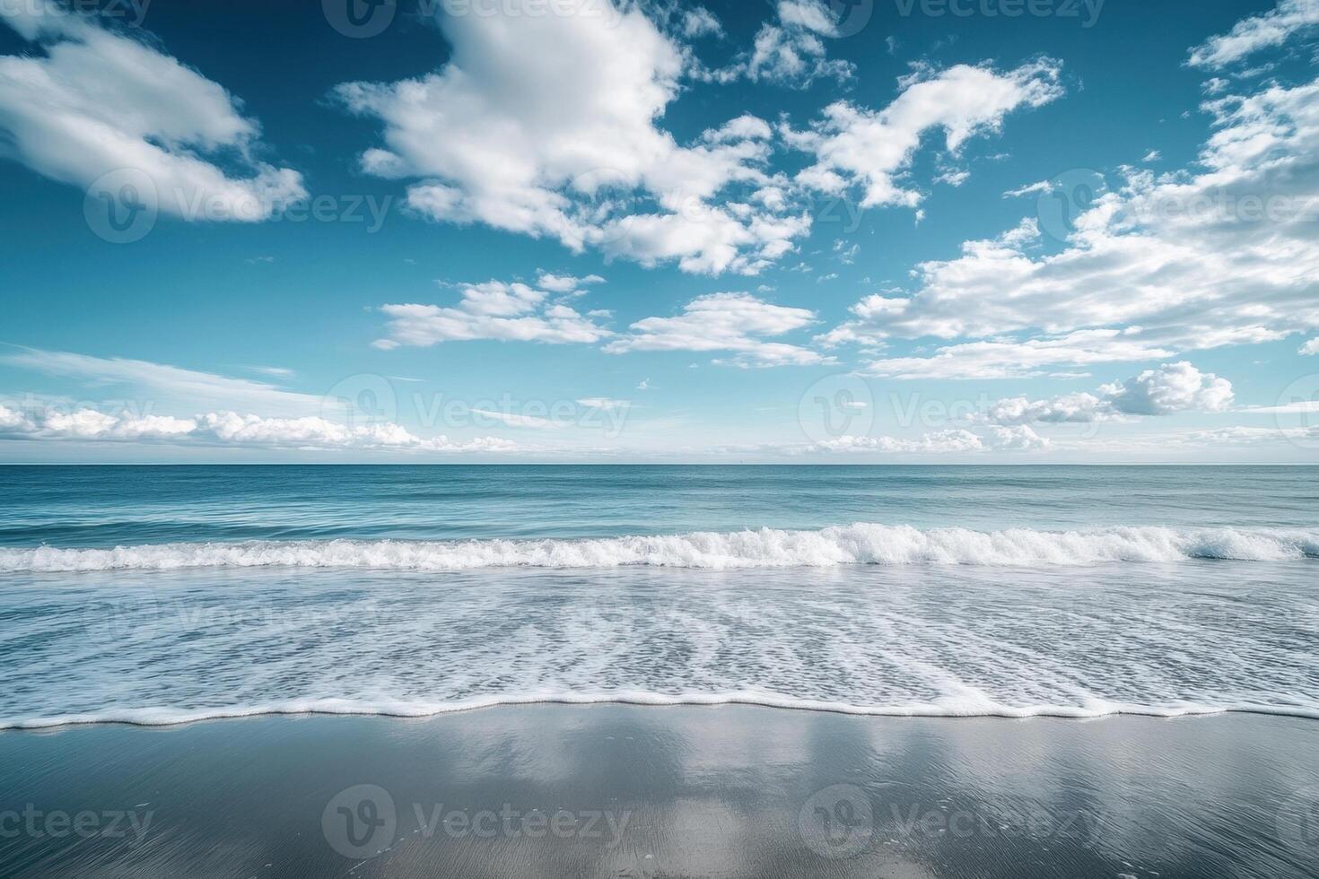 A beautiful beach with waves and clouds photo