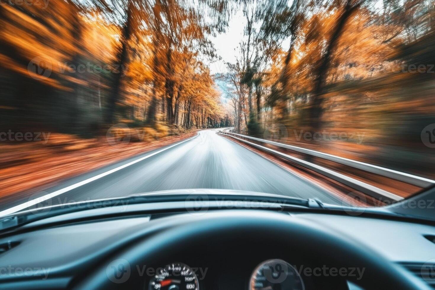 A car driving through an autumn forest. photo