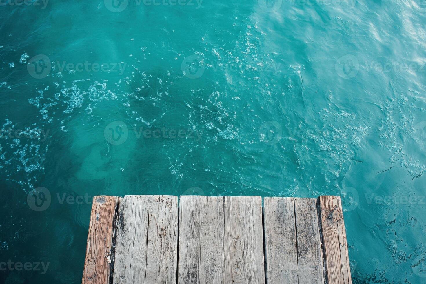 A wooden dock in the middle of the ocean photo