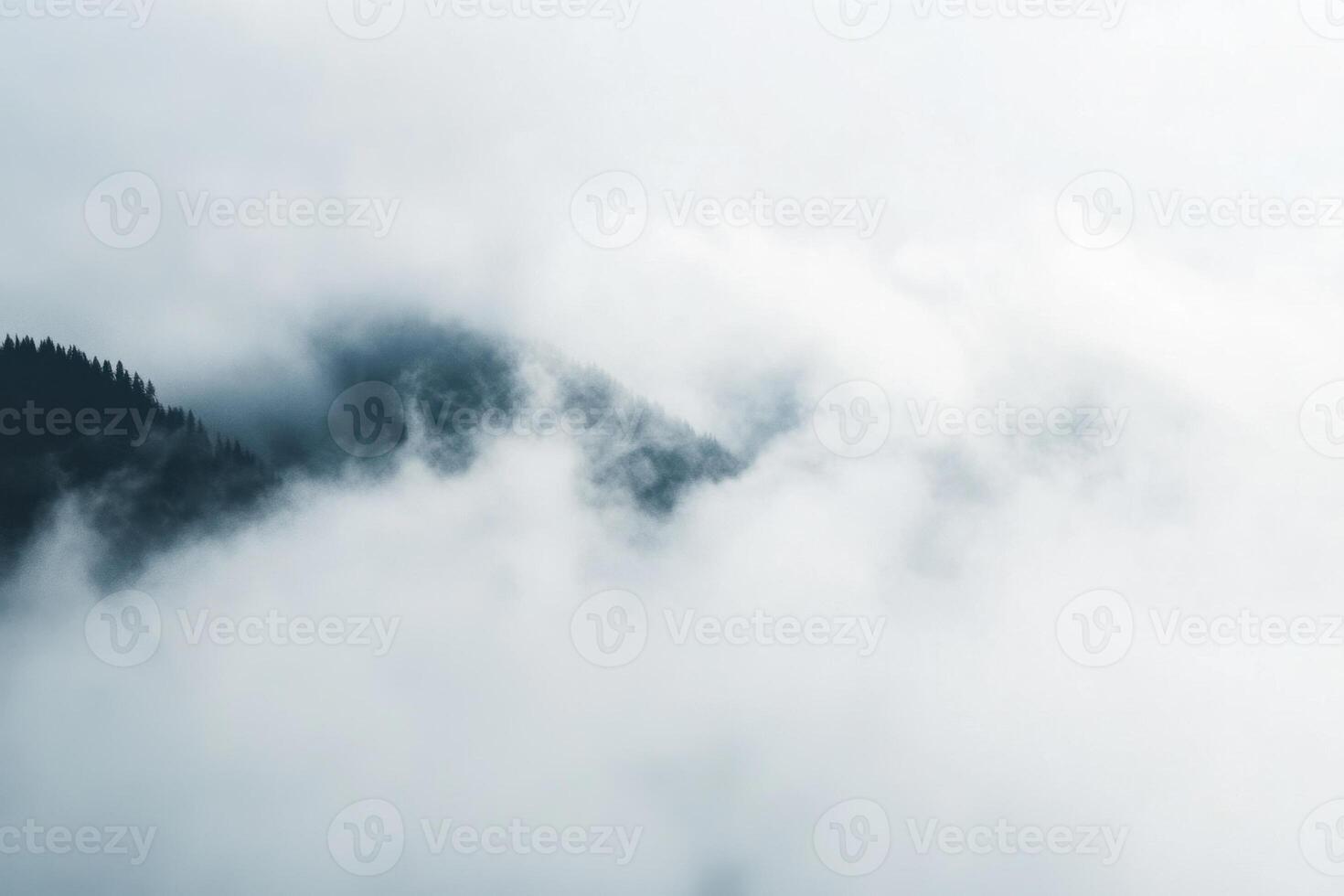 Misty mountain peak with clouds, aerial view. photo