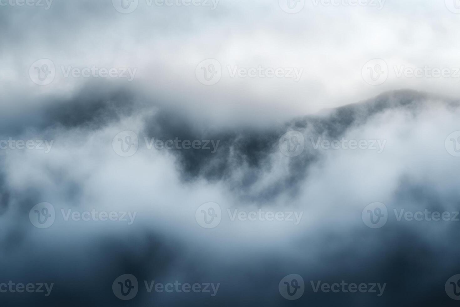 Misty Mountain Peaks Hidden in Clouds. photo