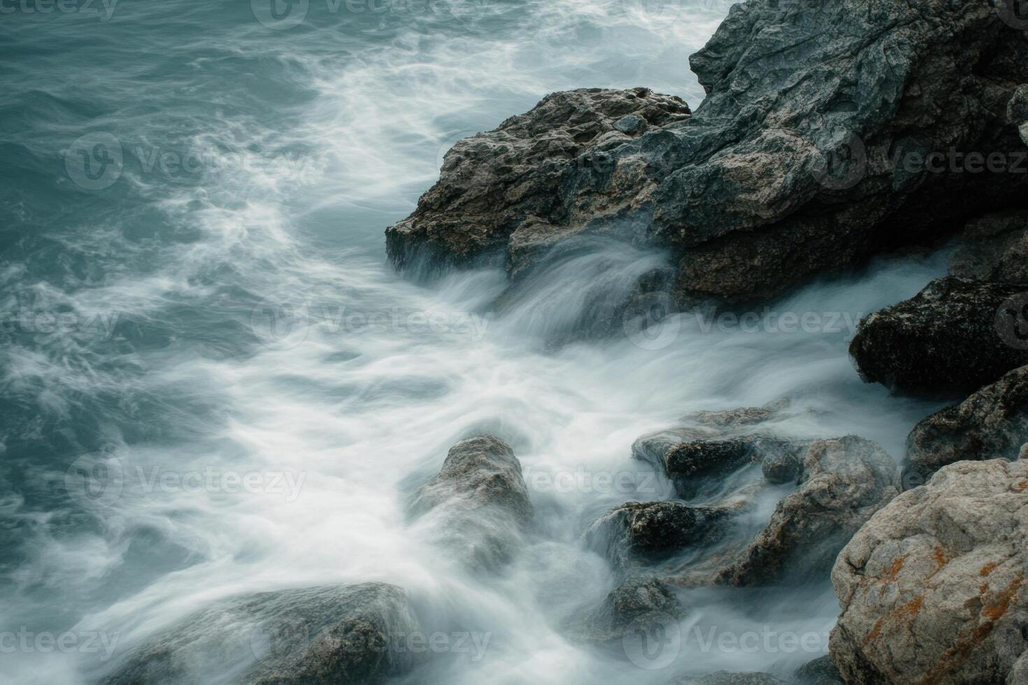 Ocean waves crashing against the rocky shore. photo