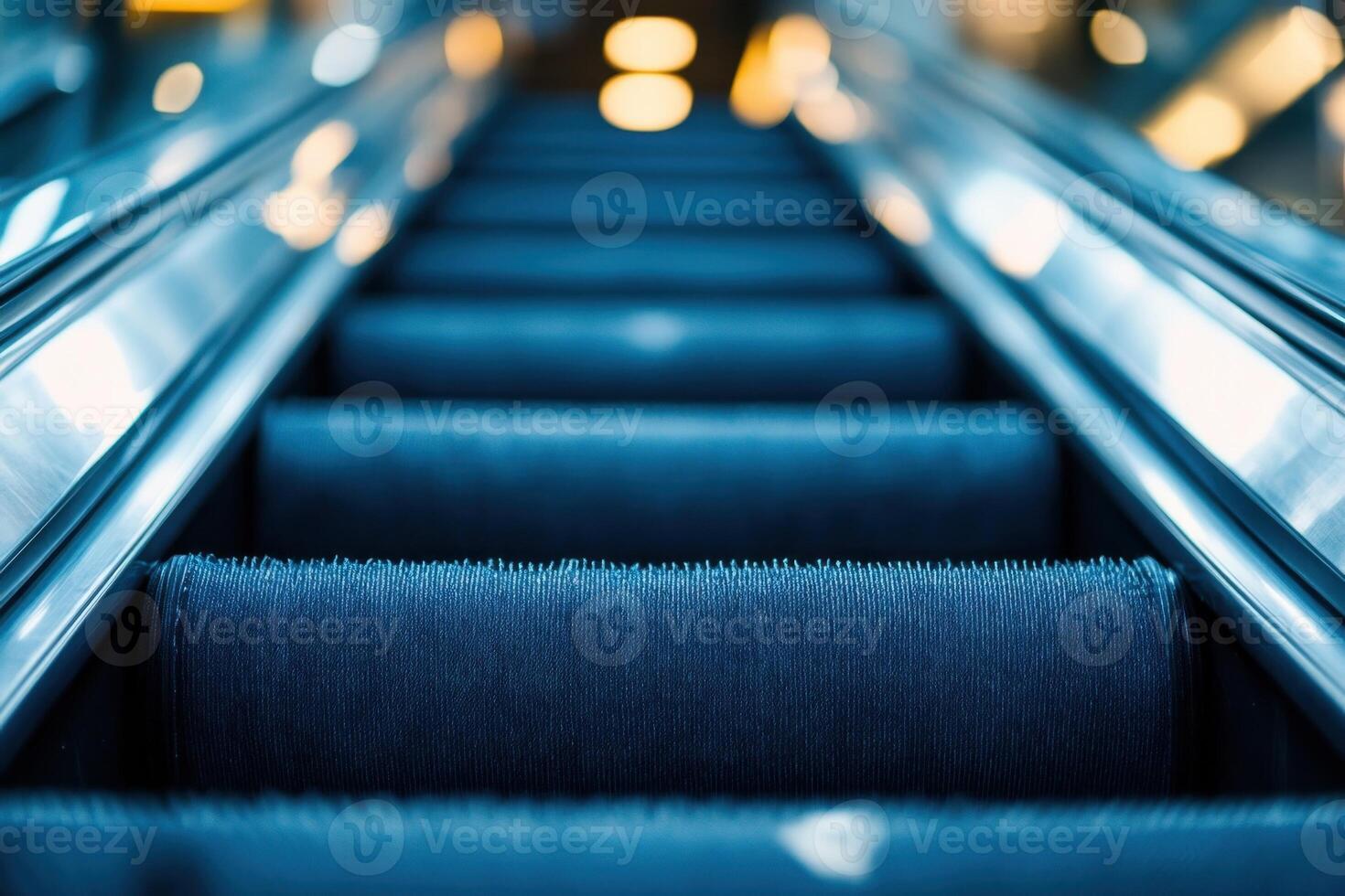 Empty escalator steps leading up to a blurry background. photo