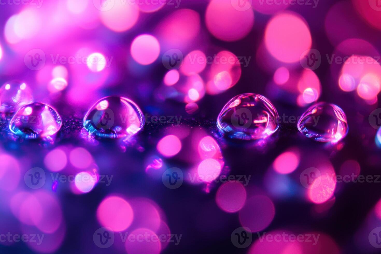 Water drops on a surface with a purple and pink bokeh background. photo