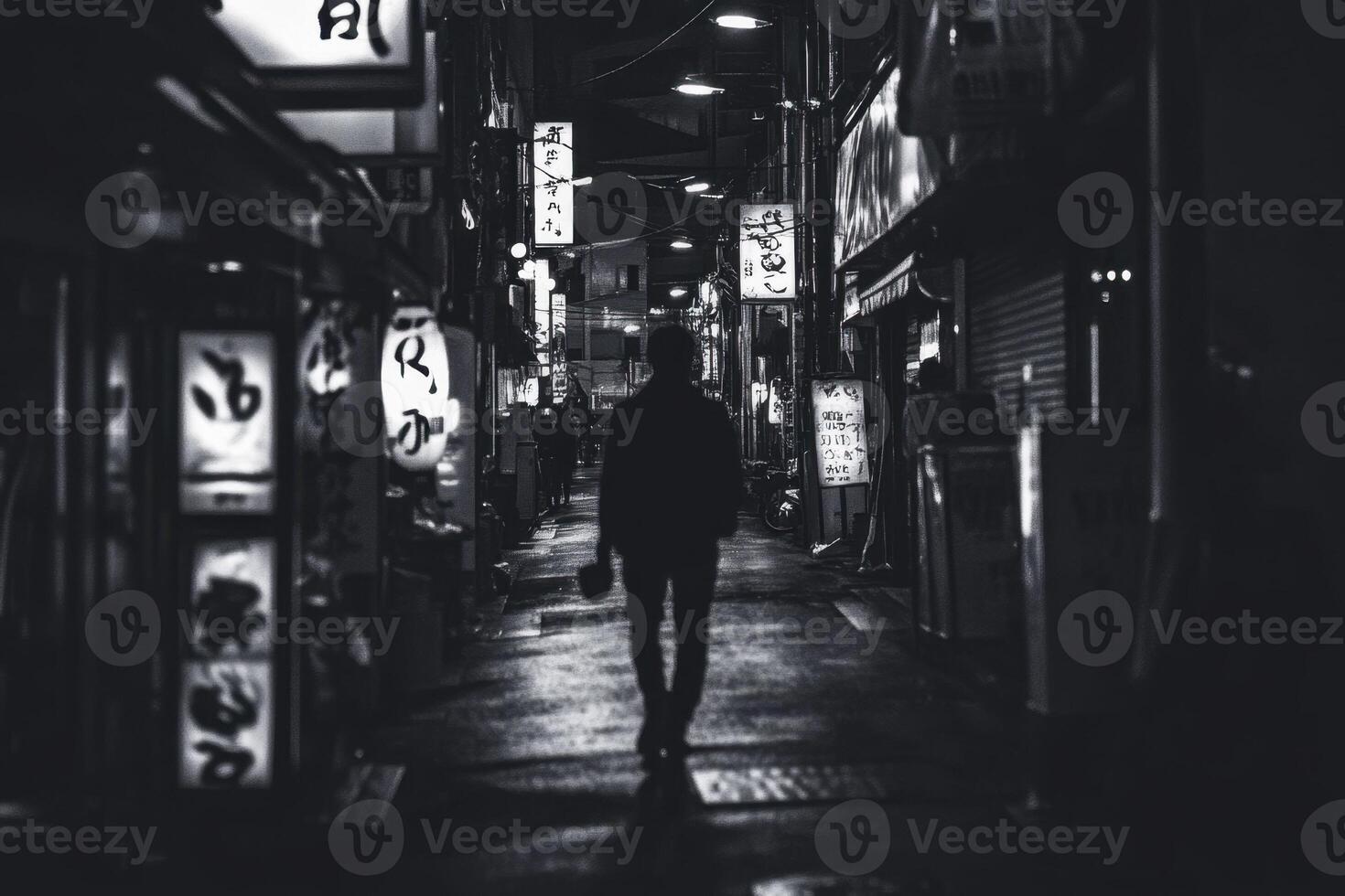 A lone figure walks down a narrow, dimly lit street in a bustling Asian city. photo