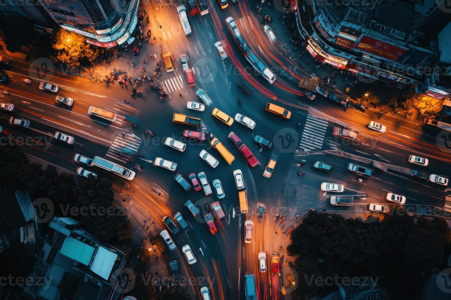 Aerial view of busy city intersection at night with traffic light trails. photo