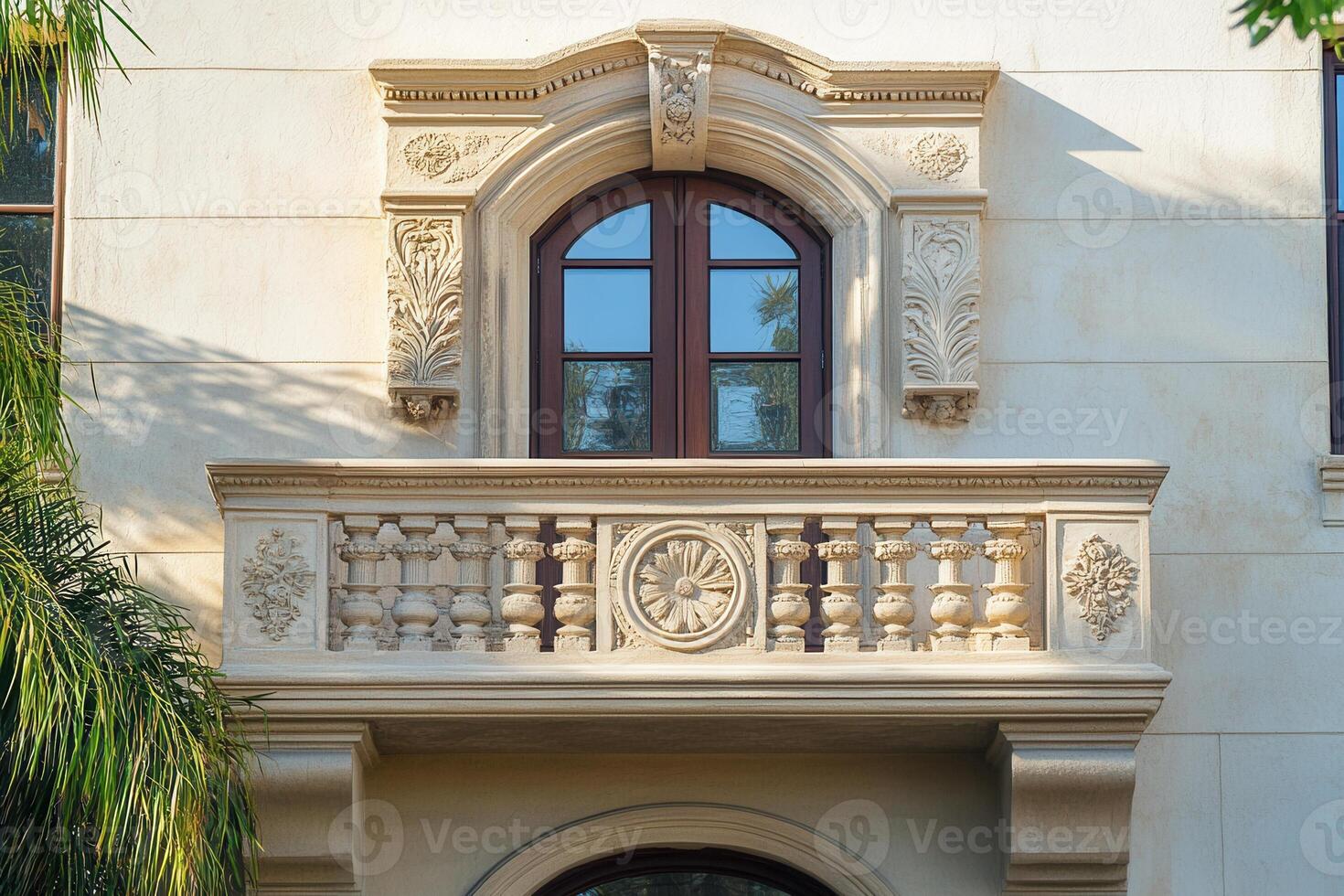 Ornate balcony with arched window and intricate stonework. photo