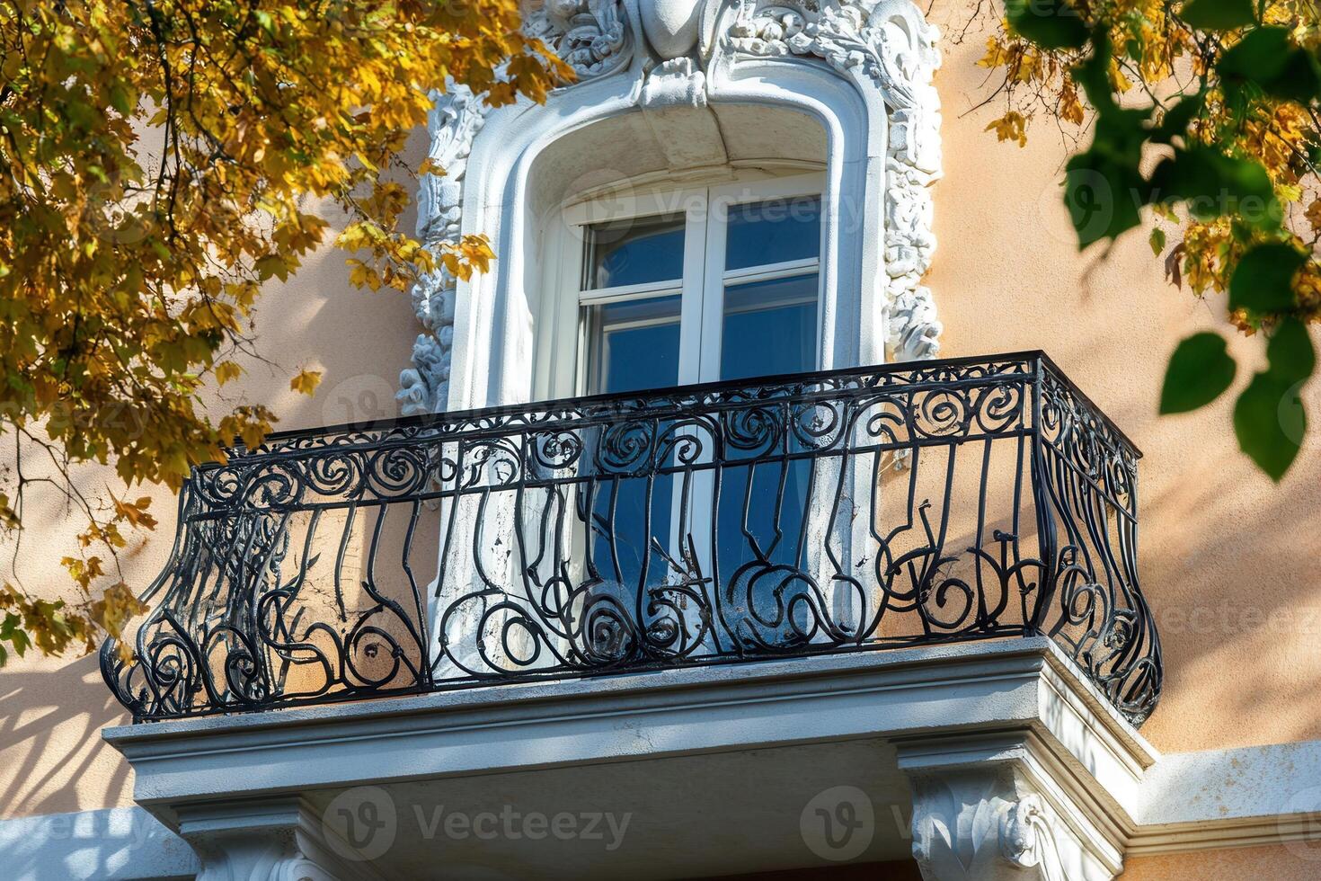 Ornate balcony with iron railing and window. photo