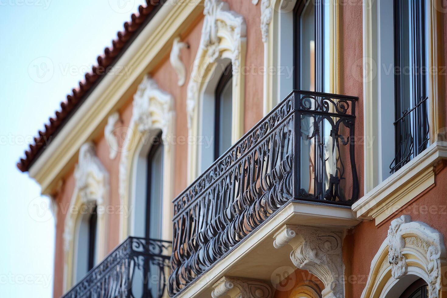 A close-up view of a balcony with ornate iron railings. photo