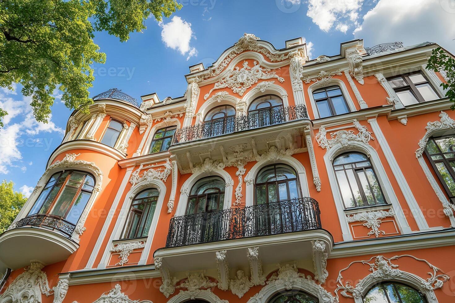 An ornate, peach-colored building with white trim and balconies. photo