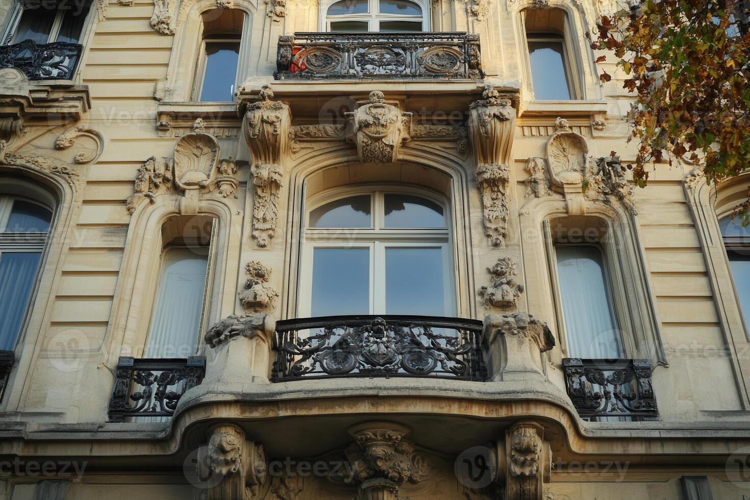 Ornate facade of a historic building with intricate details and a wrought iron balcony. photo